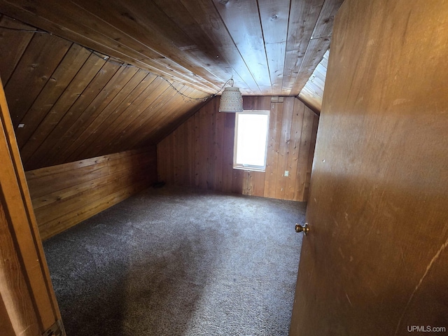 bonus room featuring wood walls, wooden ceiling, lofted ceiling, and carpet