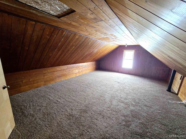 additional living space featuring lofted ceiling, wooden walls, carpet flooring, and wood ceiling