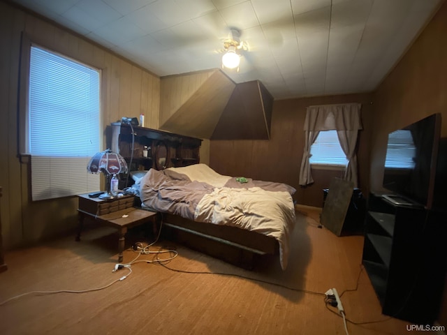 bedroom featuring wood walls