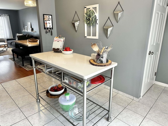 kitchen with light tile patterned floors and baseboards