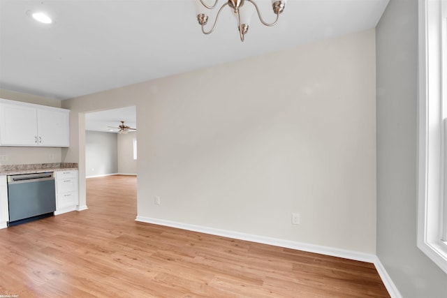 kitchen featuring stainless steel dishwasher, white cabinetry, baseboards, and light wood finished floors