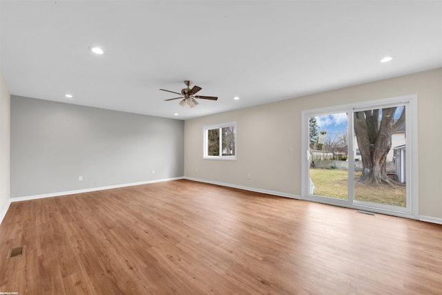 unfurnished living room with light wood-style flooring, recessed lighting, and visible vents