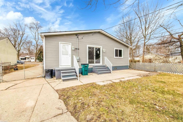 rear view of house featuring a yard, a patio, fence, and entry steps