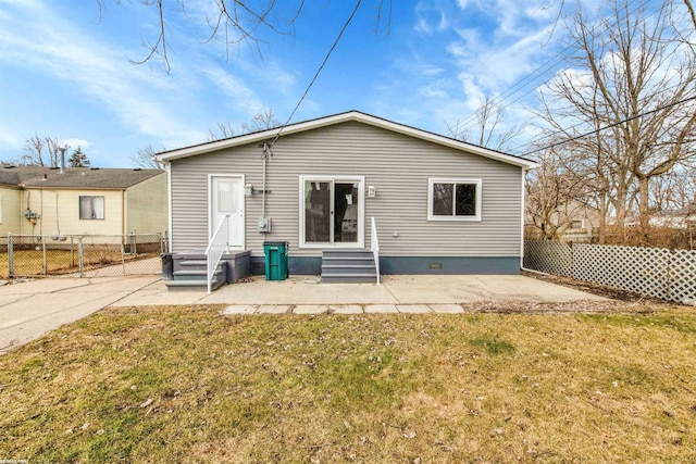 rear view of property with a yard, fence, a patio area, and entry steps