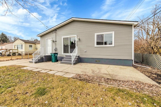 rear view of property featuring entry steps, a patio, and fence