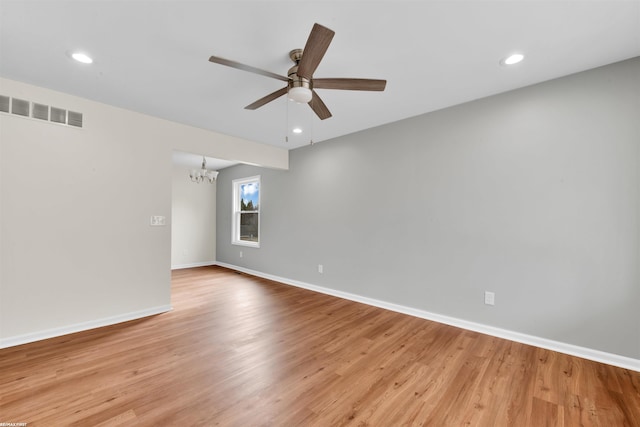 unfurnished room with visible vents, light wood-style flooring, and baseboards