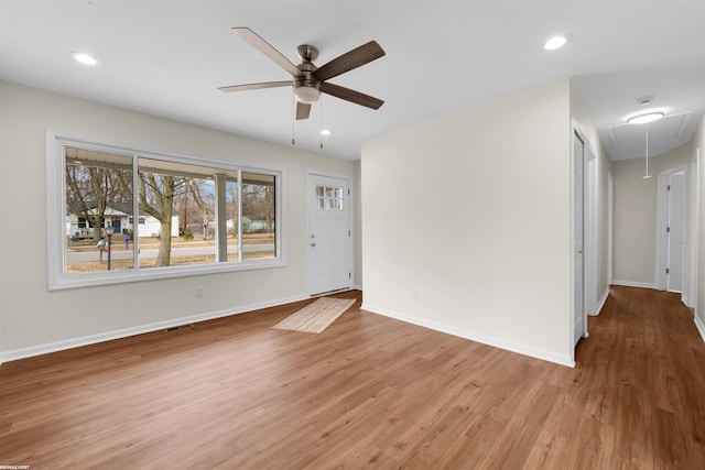 interior space with light wood finished floors, visible vents, baseboards, attic access, and recessed lighting