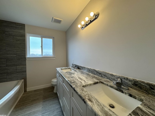 full bath featuring a sink, visible vents, baseboards, and toilet