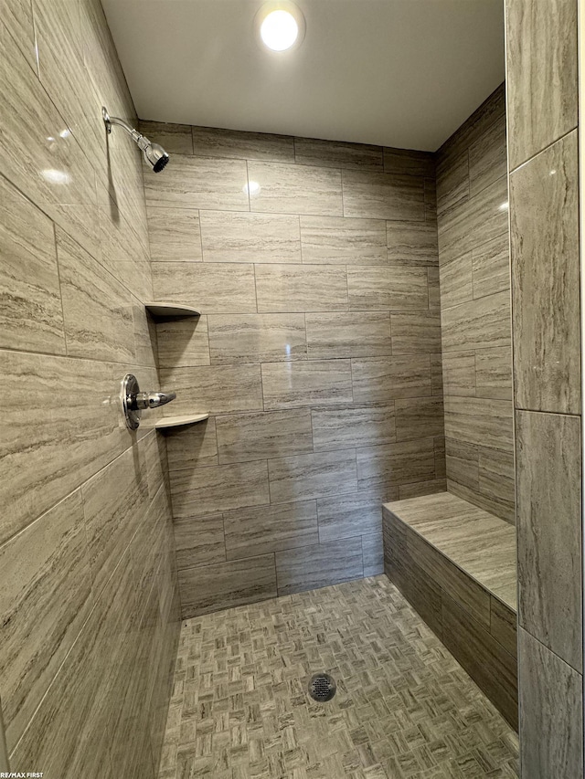 full bathroom featuring tiled shower