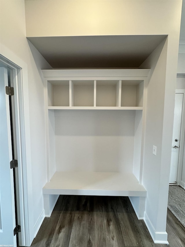 mudroom featuring baseboards and dark wood-style flooring