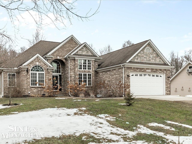 view of front of house featuring a front lawn, roof with shingles, concrete driveway, an attached garage, and brick siding