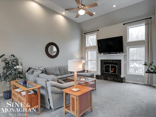 living area featuring recessed lighting, a premium fireplace, high vaulted ceiling, and carpet