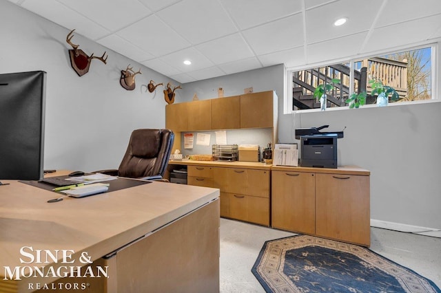 home office featuring recessed lighting, baseboards, and a drop ceiling