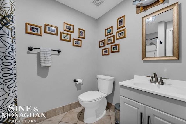 full bathroom featuring tile patterned flooring, visible vents, baseboards, toilet, and vanity