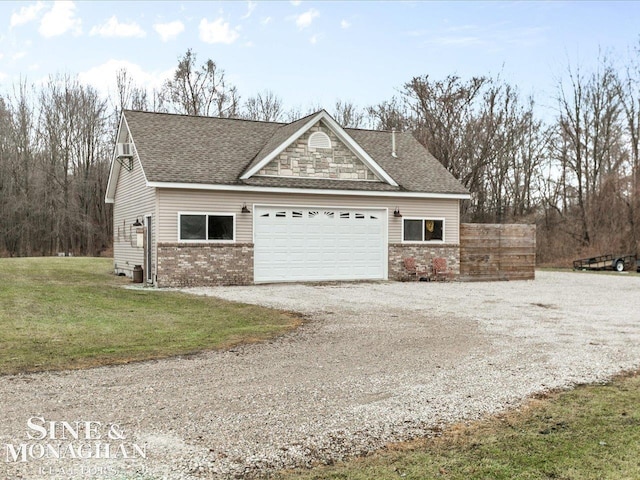 exterior space featuring a yard, roof with shingles, gravel driveway, an attached garage, and brick siding