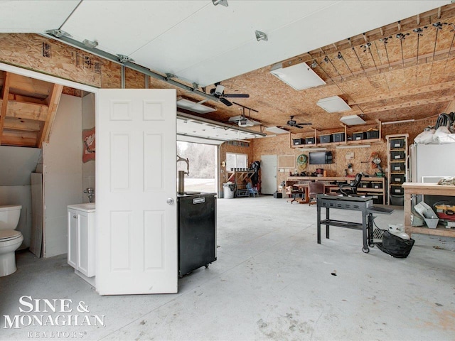 garage with a workshop area and a ceiling fan