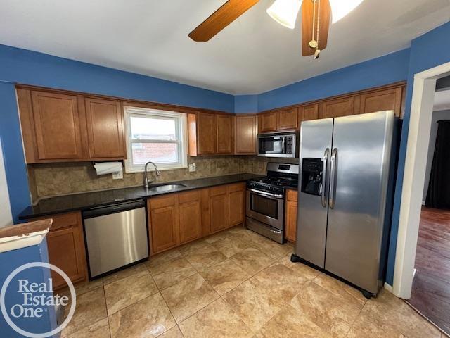 kitchen with a sink, brown cabinets, and appliances with stainless steel finishes