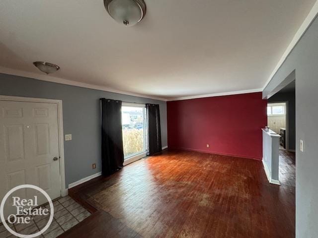 interior space with baseboards, plenty of natural light, wood finished floors, and ornamental molding