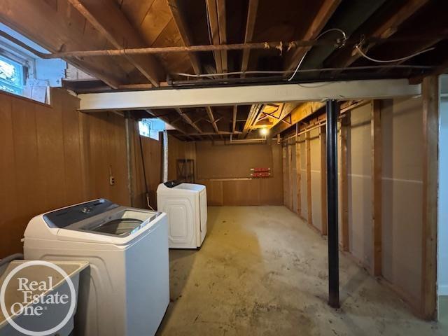 below grade area with wooden walls and independent washer and dryer