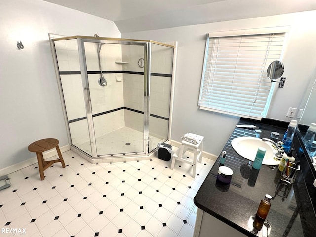 full bath with baseboards, a stall shower, and vanity