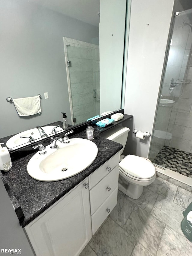 full bath featuring vanity, toilet, a stall shower, and marble finish floor