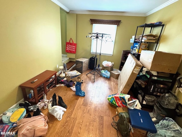 miscellaneous room featuring hardwood / wood-style flooring, crown molding, and baseboards