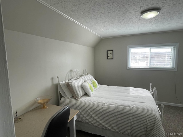 bedroom with baseboards, carpet floors, and lofted ceiling