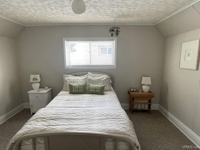 bedroom with lofted ceiling, crown molding, baseboards, and dark carpet