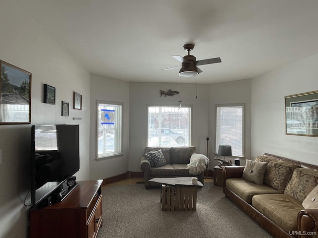 living room with baseboards, carpet, and a ceiling fan