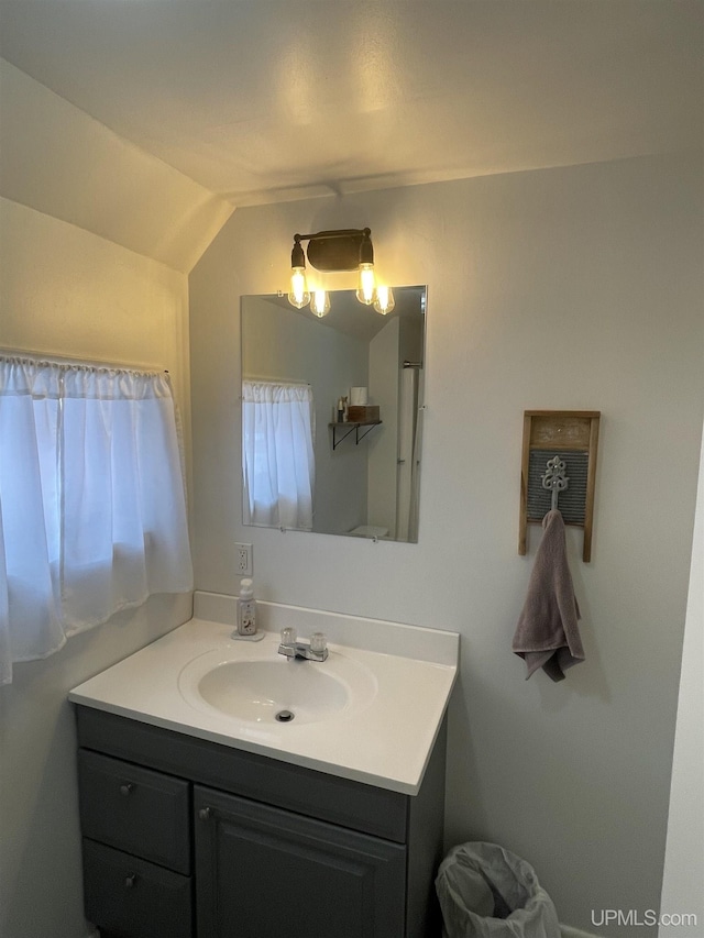 bathroom featuring vanity and vaulted ceiling