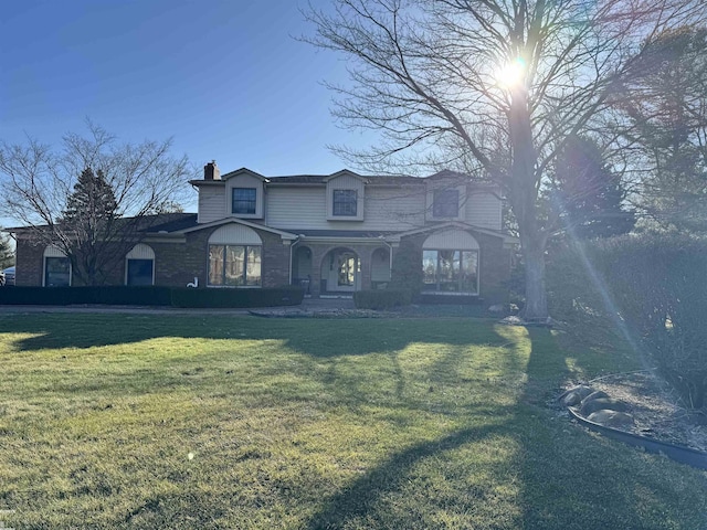 view of front of property with a chimney and a front lawn