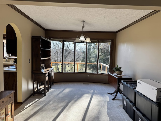 interior space with visible vents, arched walkways, and an inviting chandelier