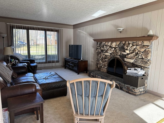 carpeted living room with a stone fireplace and a textured ceiling