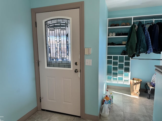 foyer featuring tile patterned flooring and baseboards