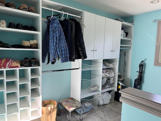 walk in closet with tile patterned flooring