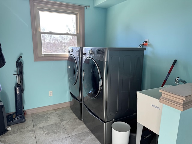 laundry room featuring independent washer and dryer, a sink, tile patterned flooring, baseboards, and laundry area