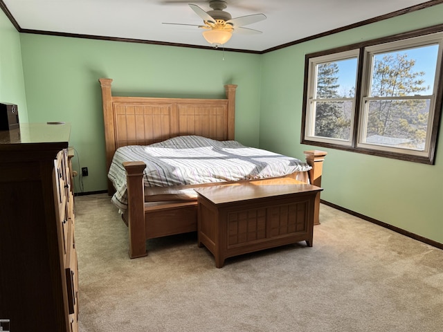 bedroom with light colored carpet, baseboards, and ornamental molding