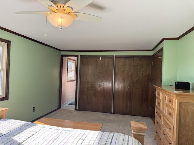 unfurnished bedroom featuring ceiling fan, baseboards, light carpet, and ornamental molding