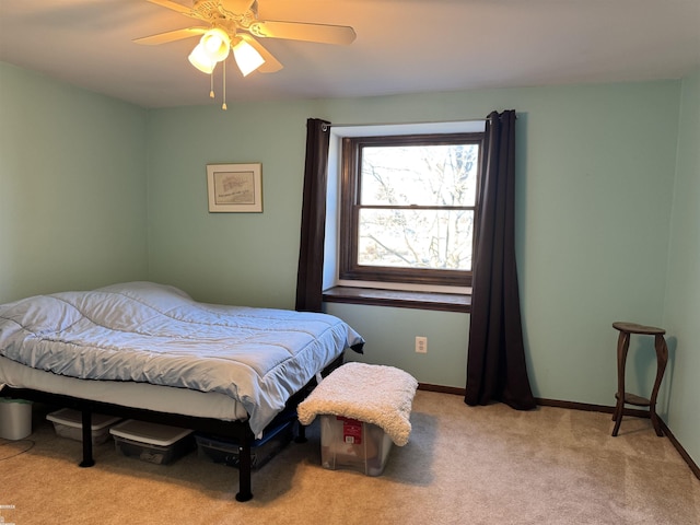 carpeted bedroom featuring baseboards and a ceiling fan