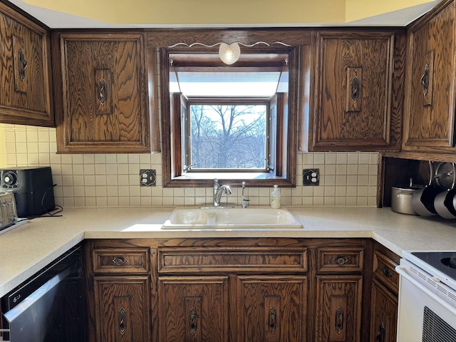 kitchen with a sink, dishwashing machine, dark brown cabinetry, and decorative backsplash