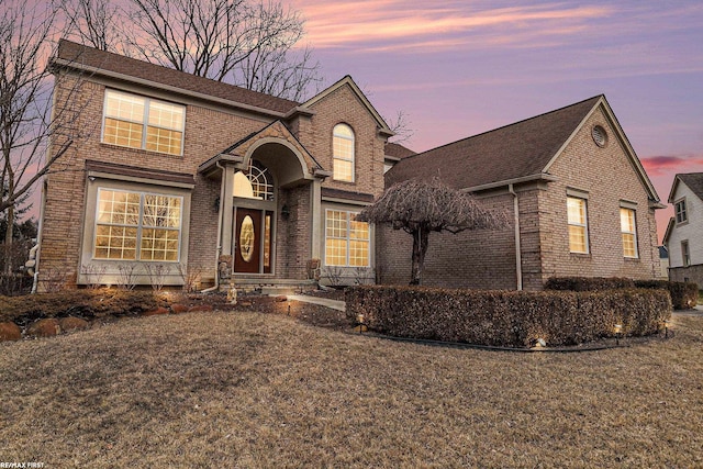 traditional-style house featuring brick siding