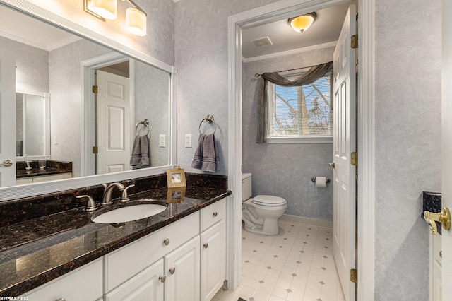 bathroom with tile patterned floors, toilet, ornamental molding, baseboards, and vanity