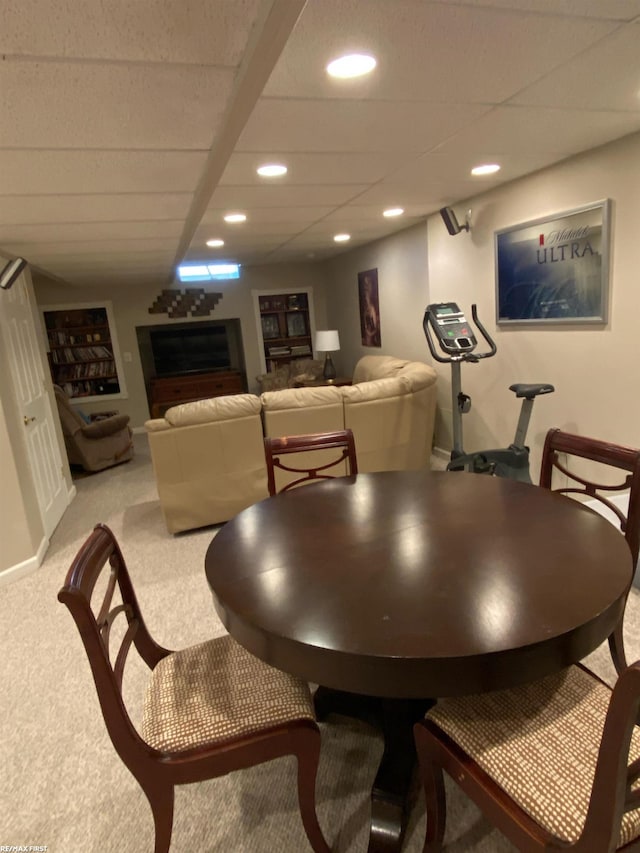 dining area featuring recessed lighting, a drop ceiling, baseboards, and light colored carpet