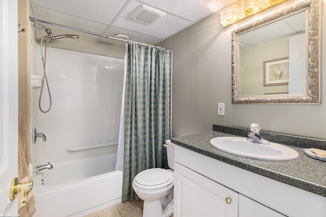 bathroom with visible vents, shower / bathtub combination with curtain, toilet, a drop ceiling, and vanity