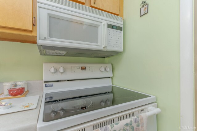 details featuring white appliances and light countertops