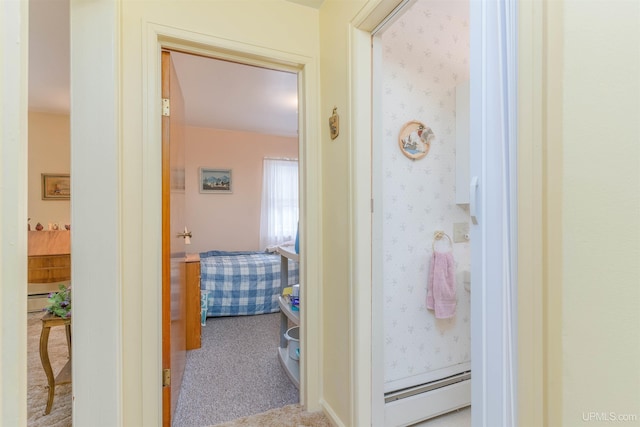 corridor featuring baseboard heating, wallpapered walls, and carpet floors