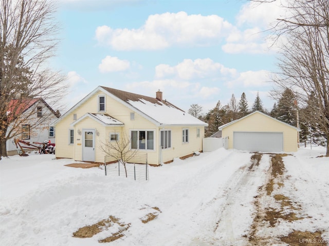 view of front of house featuring a chimney, an outdoor structure, and a garage