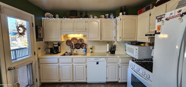 kitchen with a sink, under cabinet range hood, white appliances, white cabinets, and light countertops