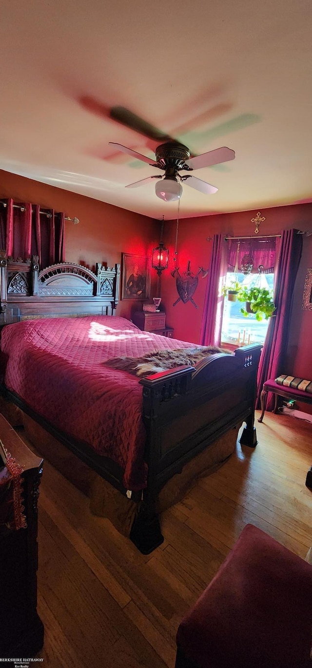 bedroom with hardwood / wood-style floors and a ceiling fan