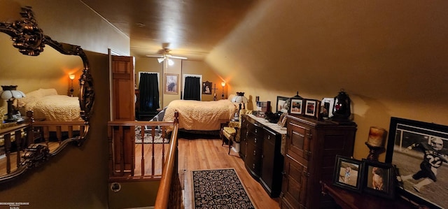 bedroom with light wood-style flooring and lofted ceiling